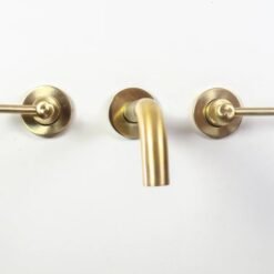 Brushed brass wall mounted bathroom vessel sink faucet with simple lever handles